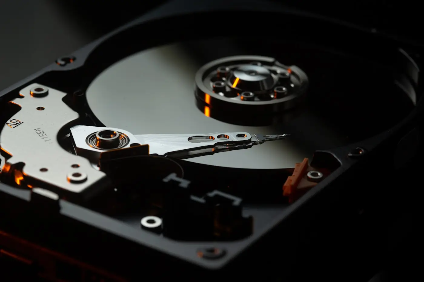 Open hard disk drive showing the platter and read head